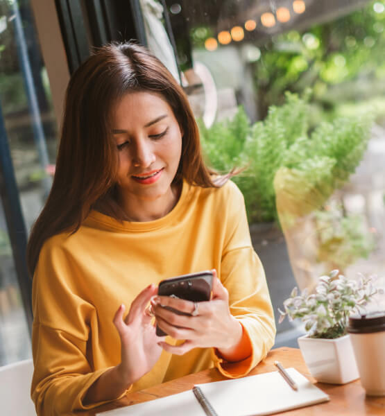 Lady on her phone looking at checking account options.