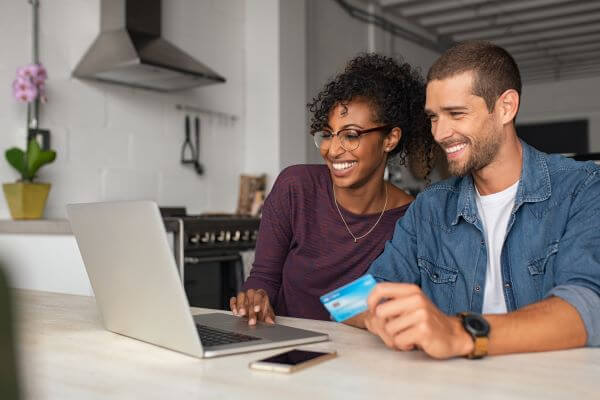 Couple looking at laptop together.