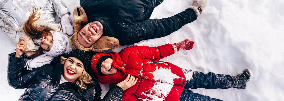 happy family playing in the snow.