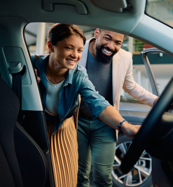 couple looking in new car