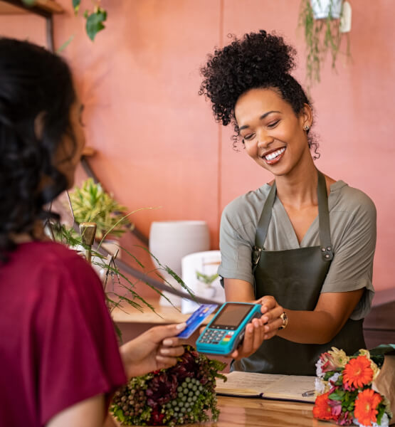 Business owner and customer tapping card to pay.