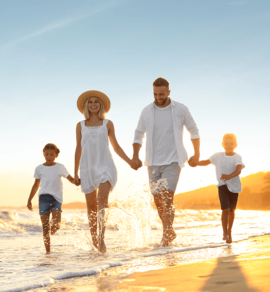 Family running on the beach