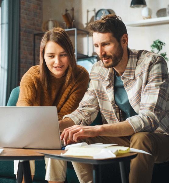 Couple looking at laptop screen for home refinancing options