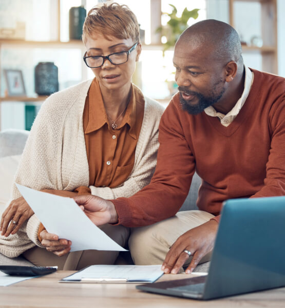 Couple looking at list and selecting a high yield checking account. 