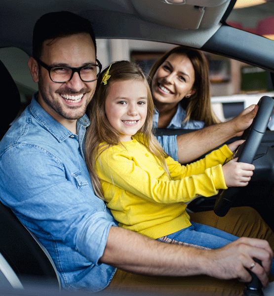 Couple and kid sitting inside a new vehicle