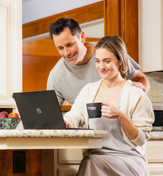 Couple looking at the laptop screen